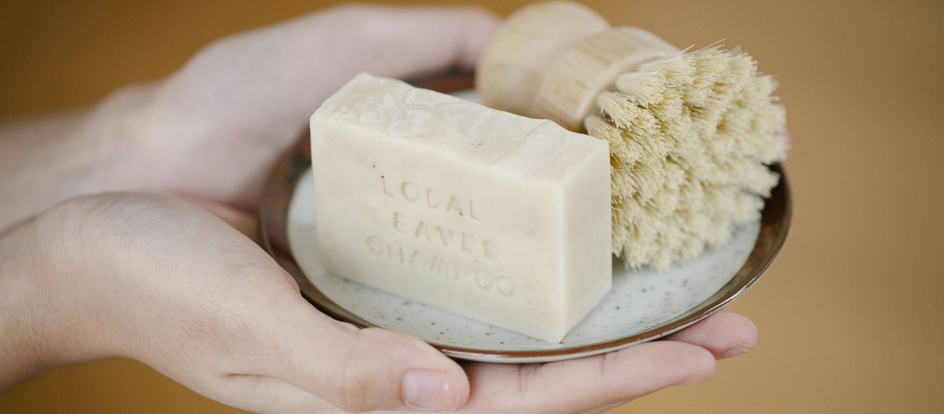 Crop person with soap in brush